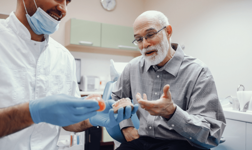 Patient discussing dental implant options with a dentist